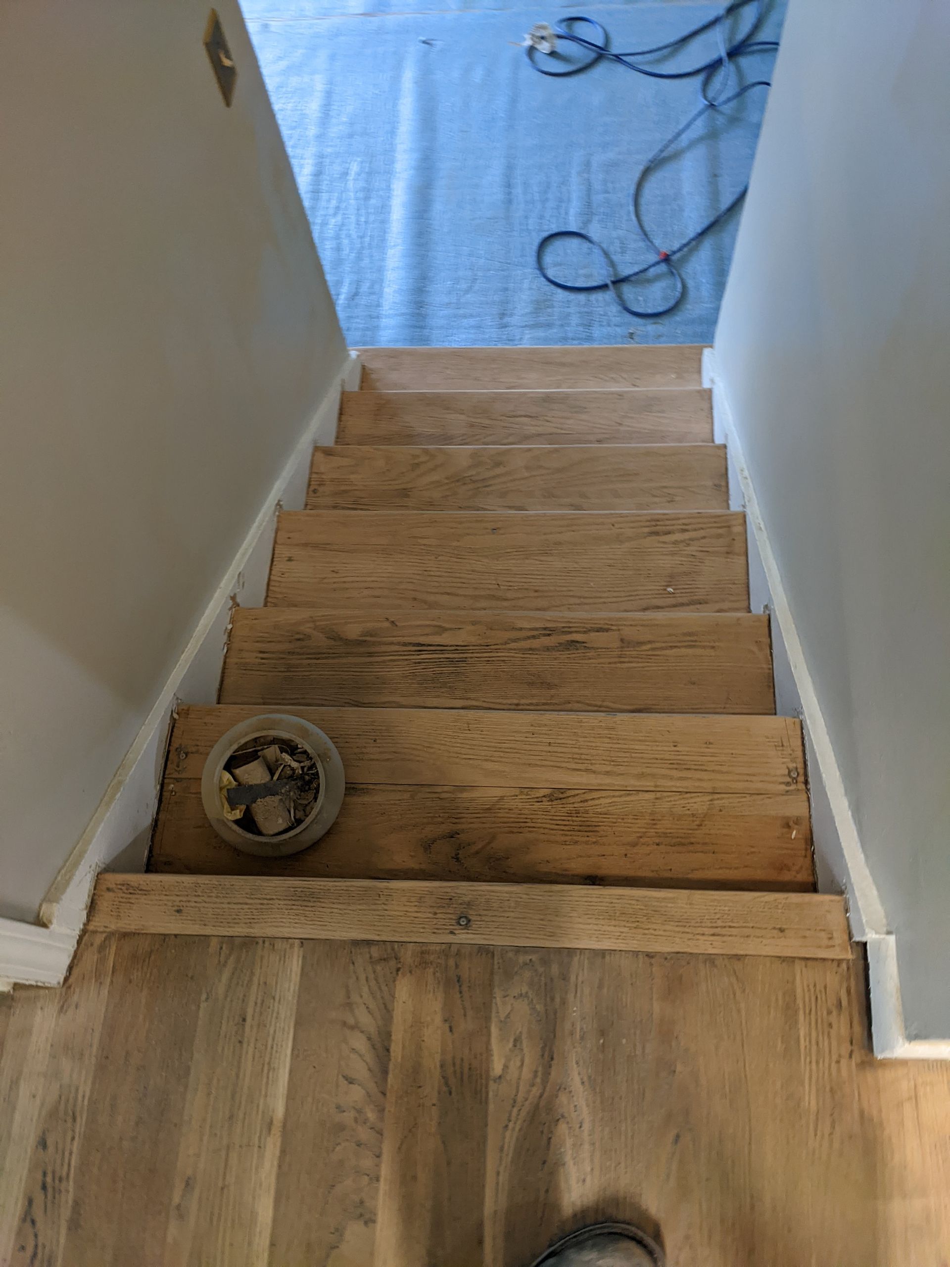 A person is standing on a set of wooden stairs.