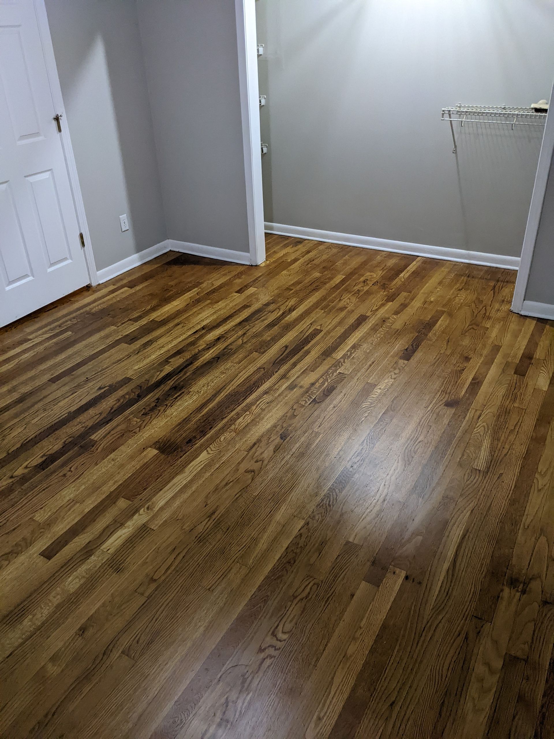 A room with hardwood floors and a door.