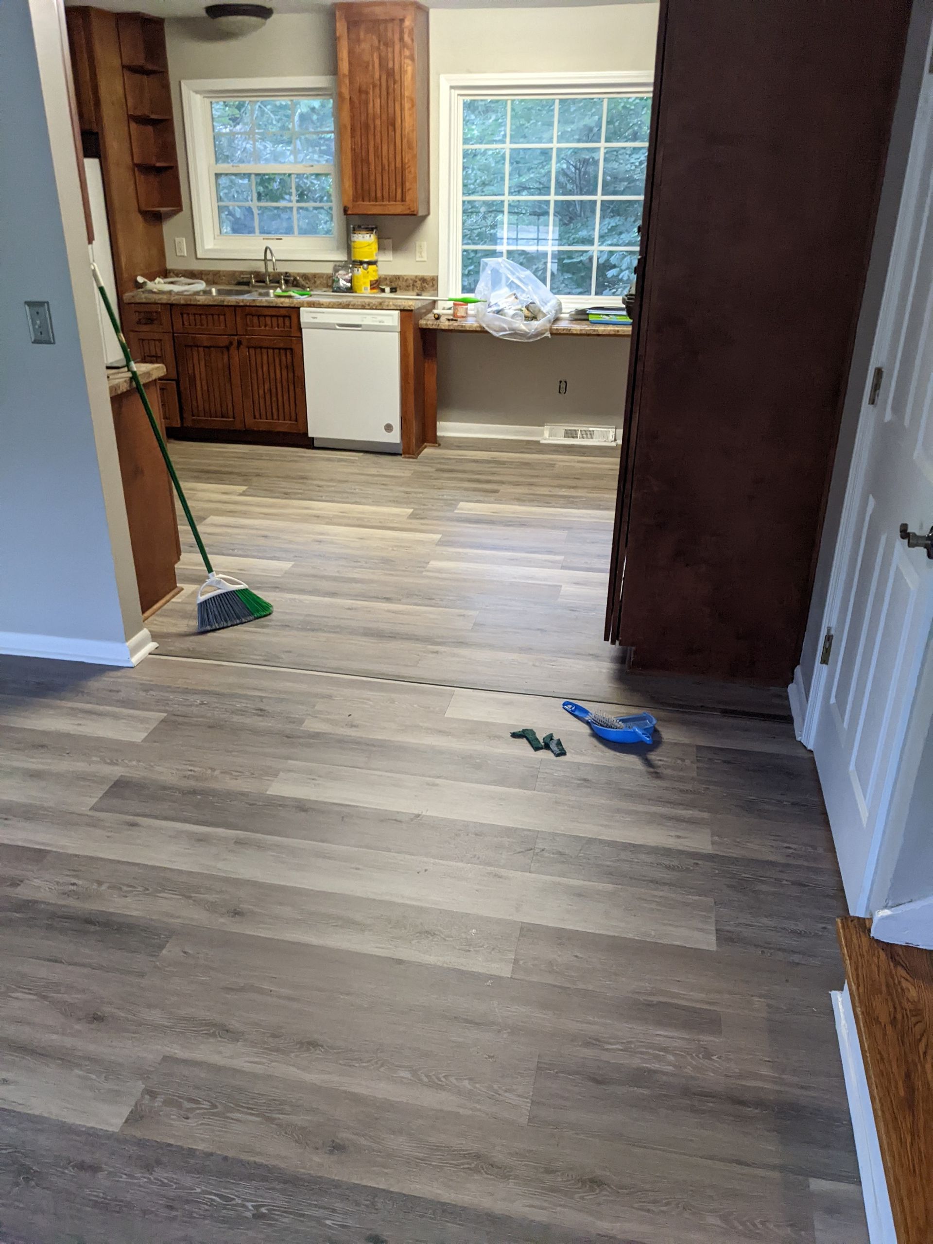 A kitchen with hardwood floors and a window.