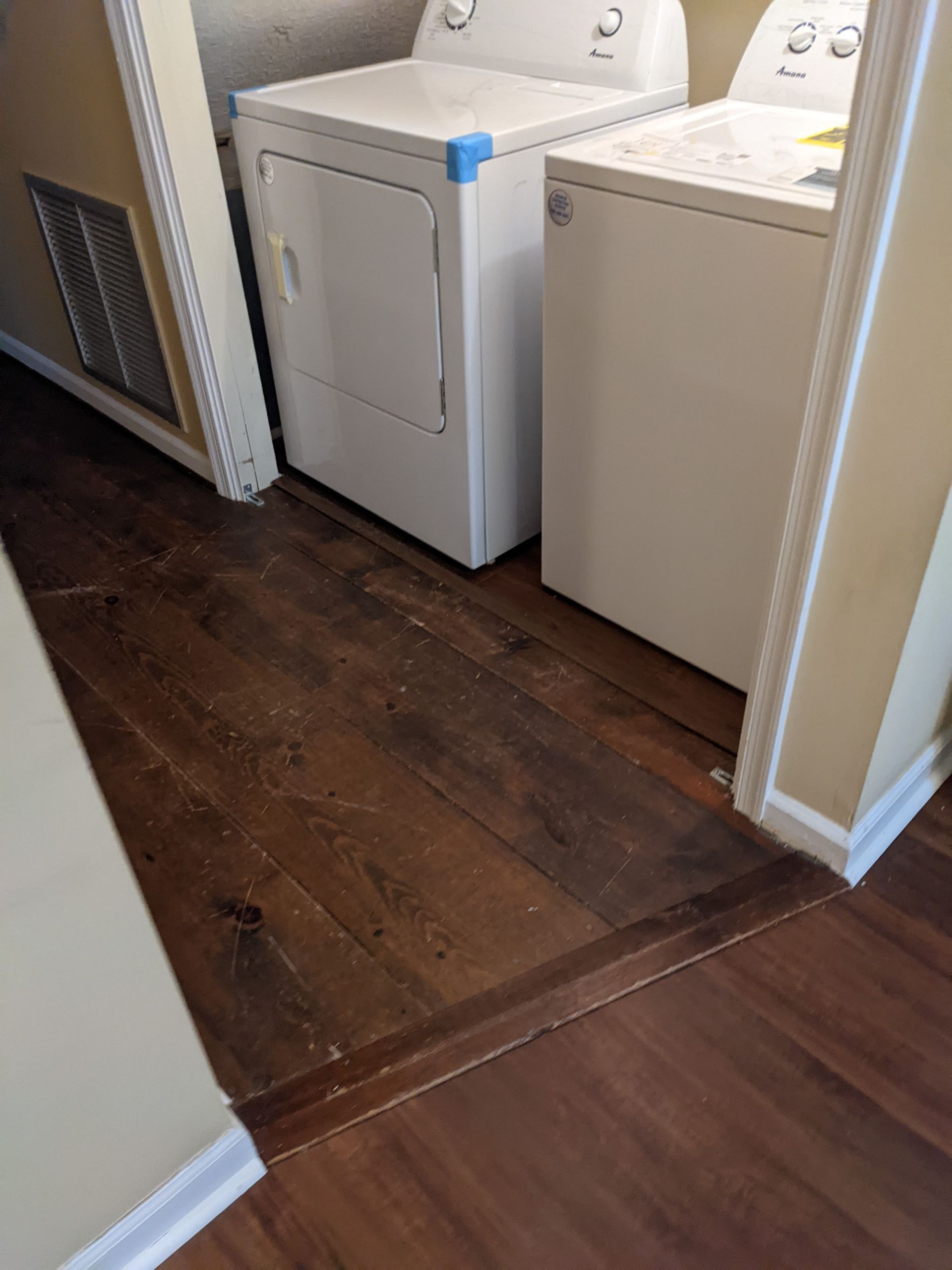 A washer and dryer are sitting next to each other in a laundry room.