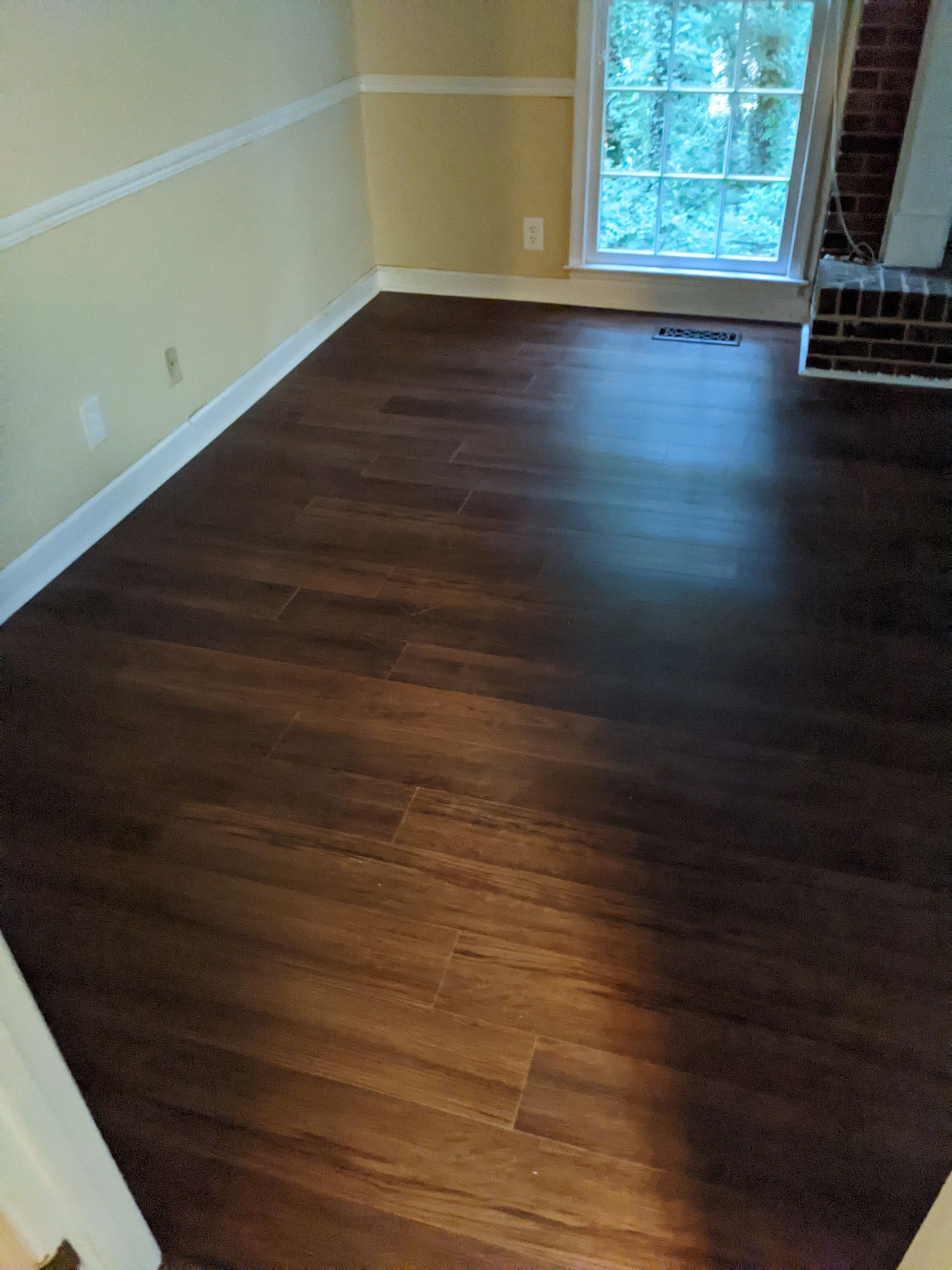A living room with hardwood floors and a fireplace.