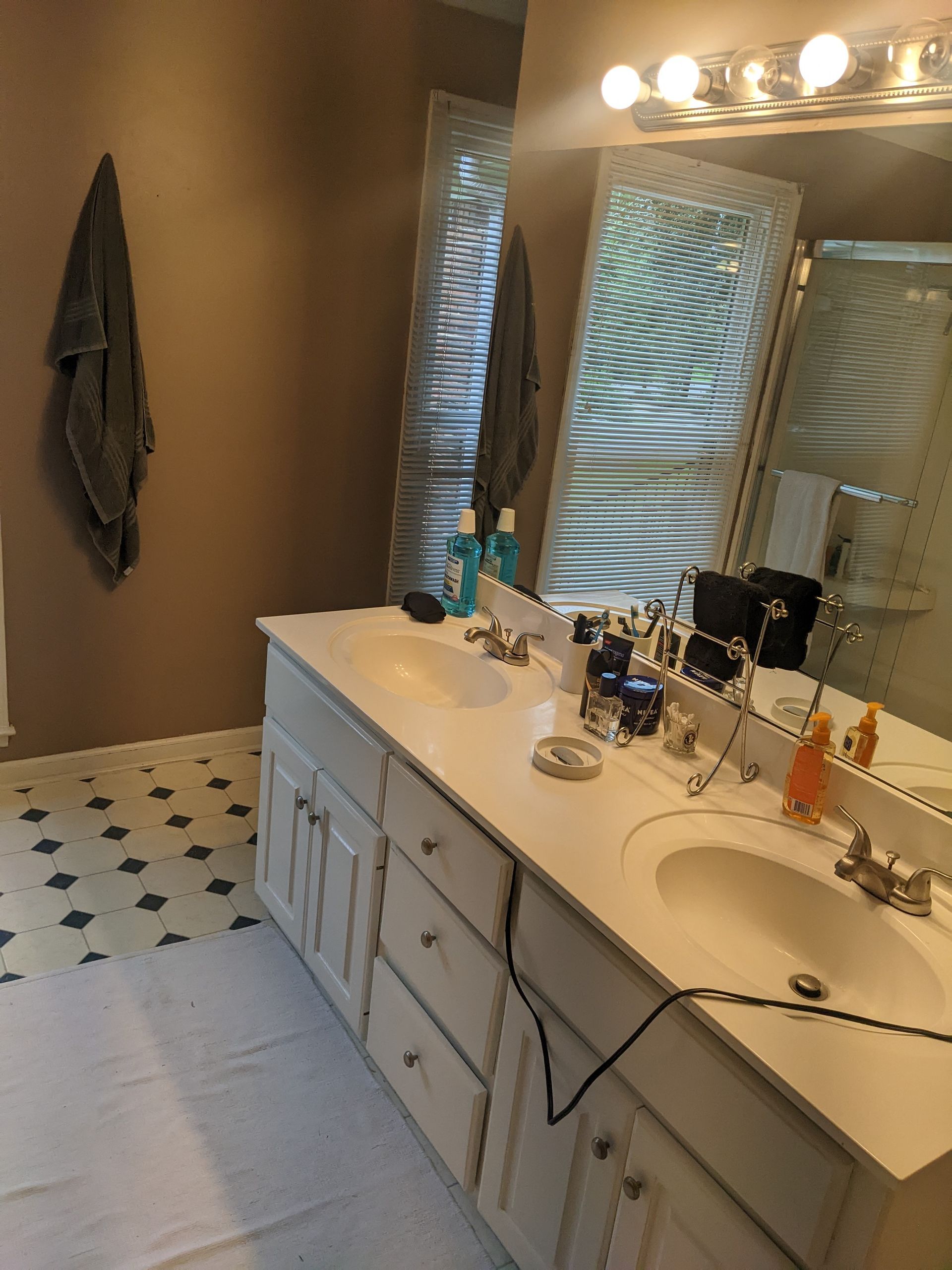 A bathroom with two sinks and a large mirror