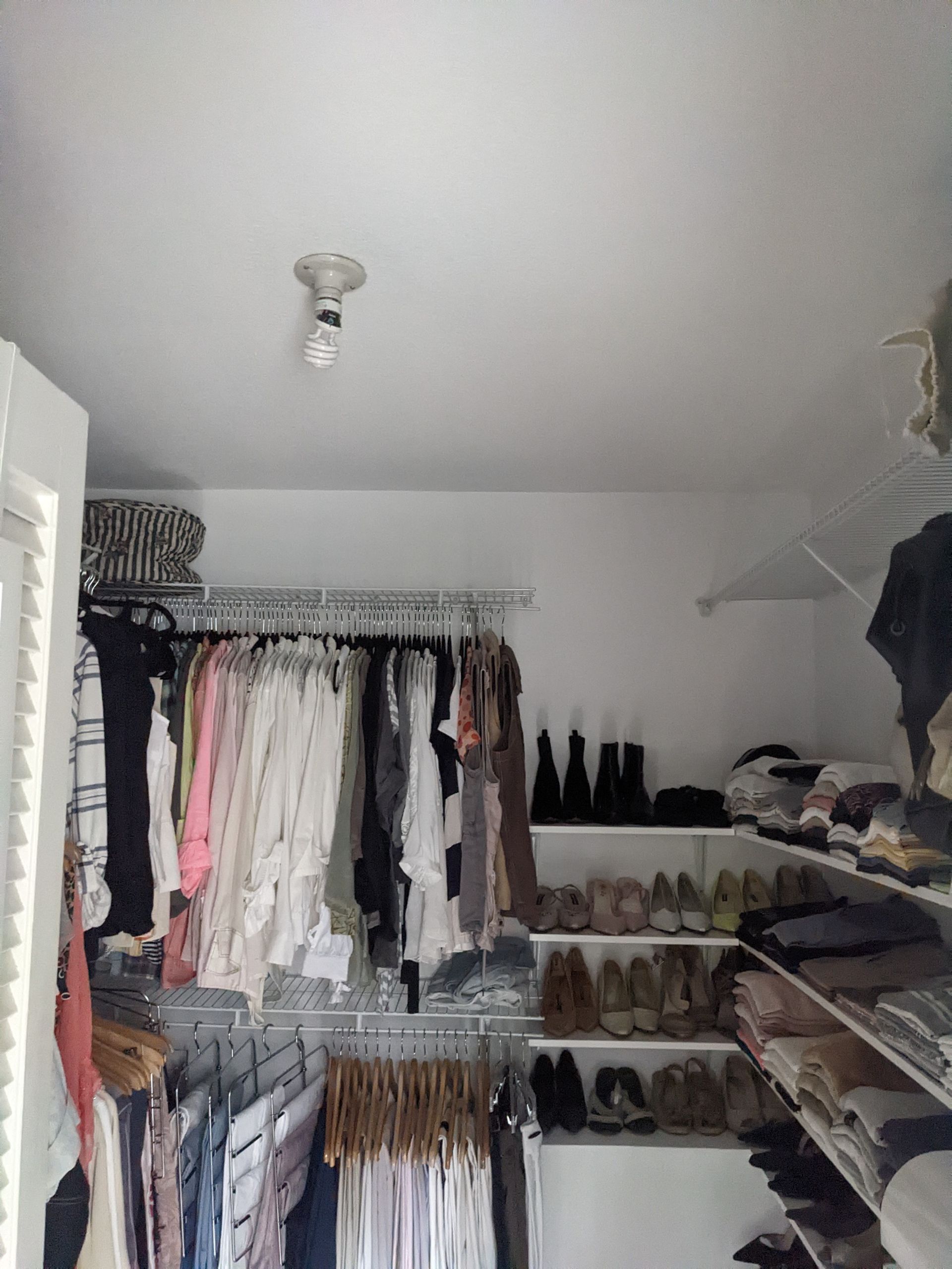 A closet filled with lots of clothes and shoes