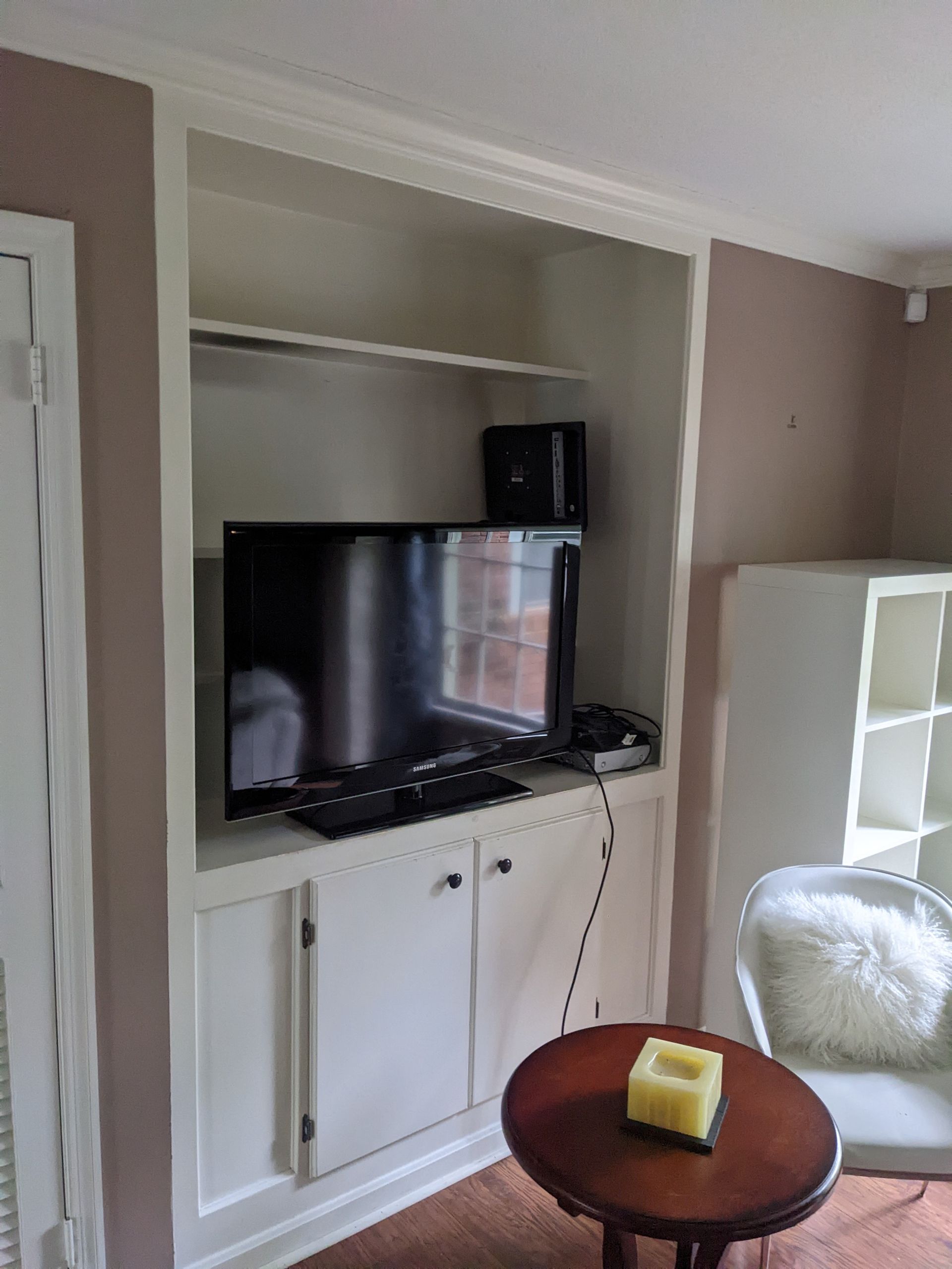 A living room with a flat screen tv and a table