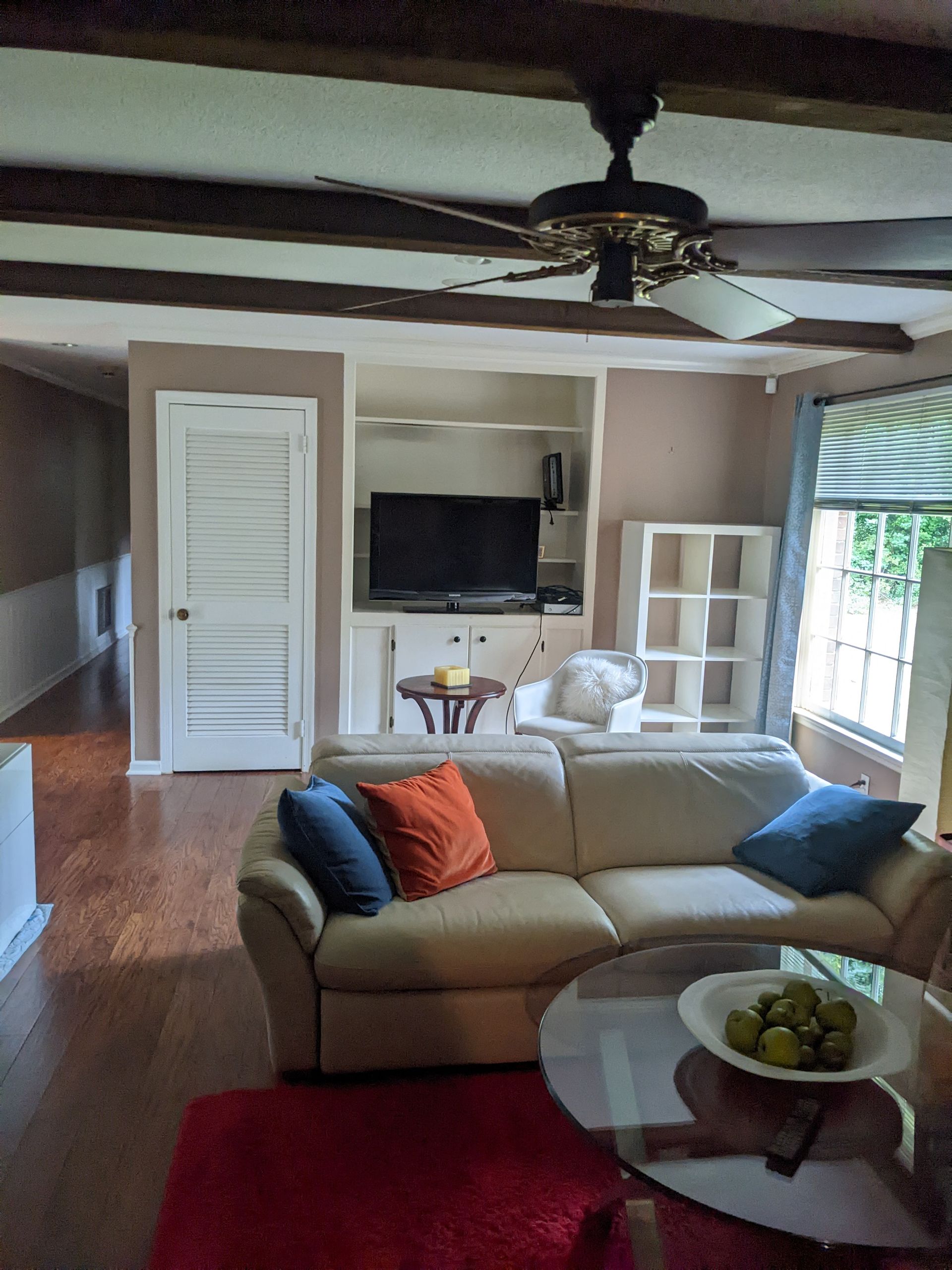 A living room with a couch and a ceiling fan
