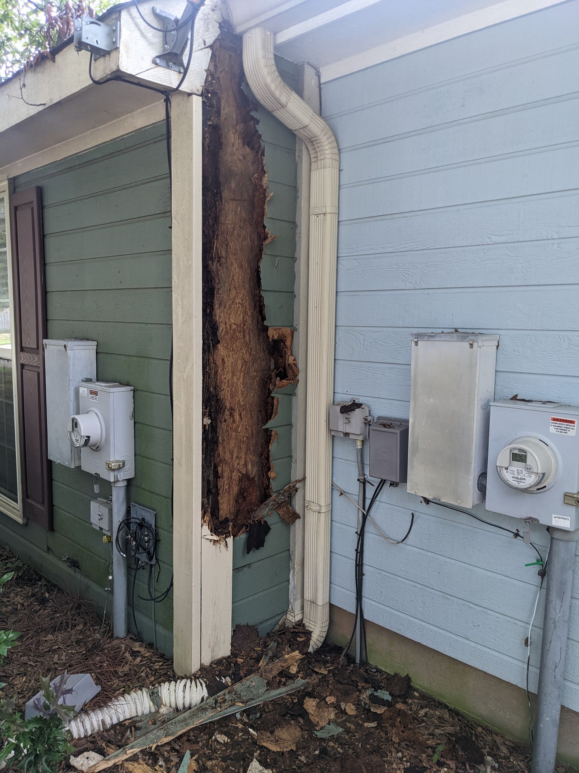 A house with a large hole in the side of it.