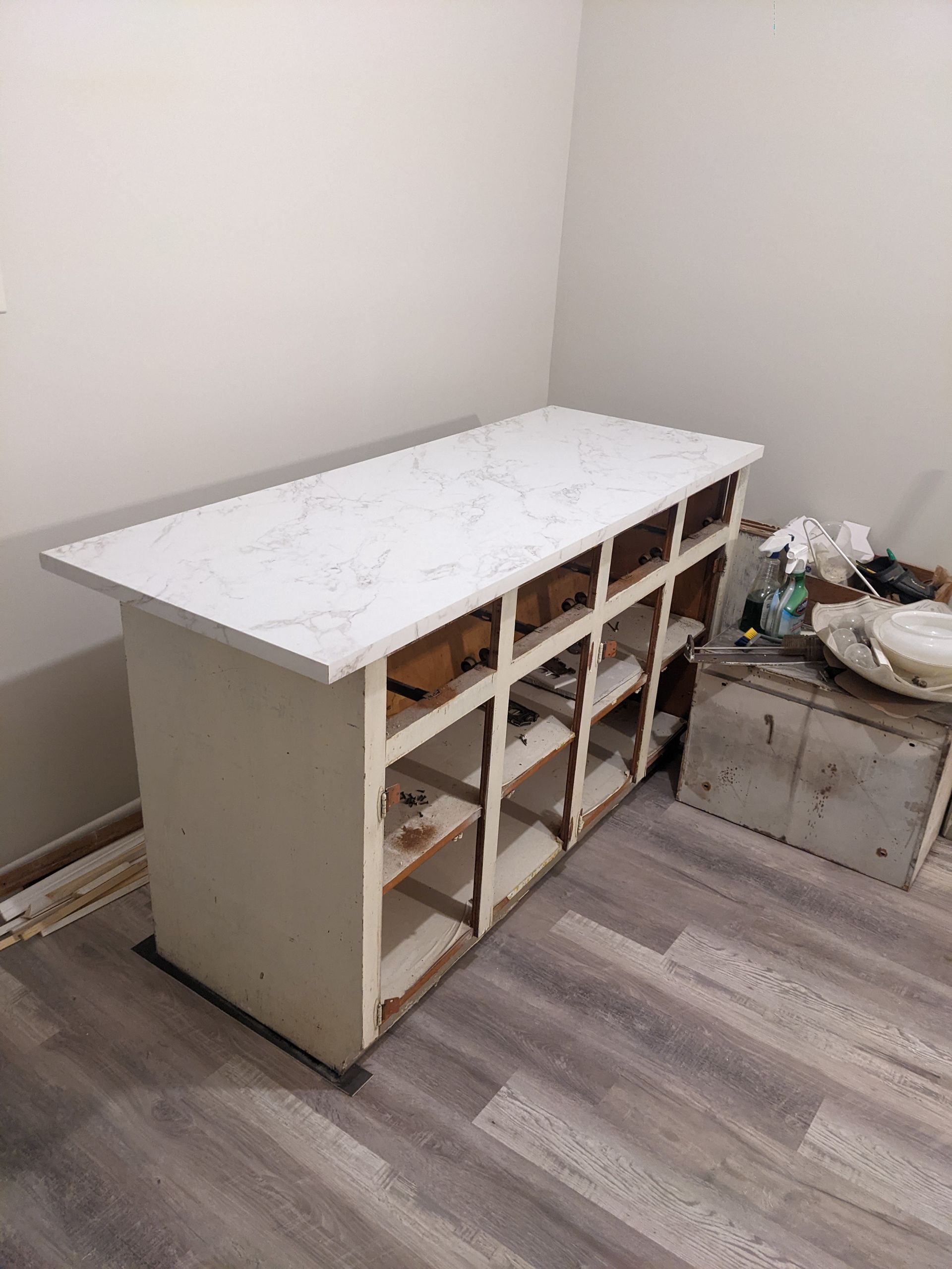A white table with a marble top is sitting in a room.