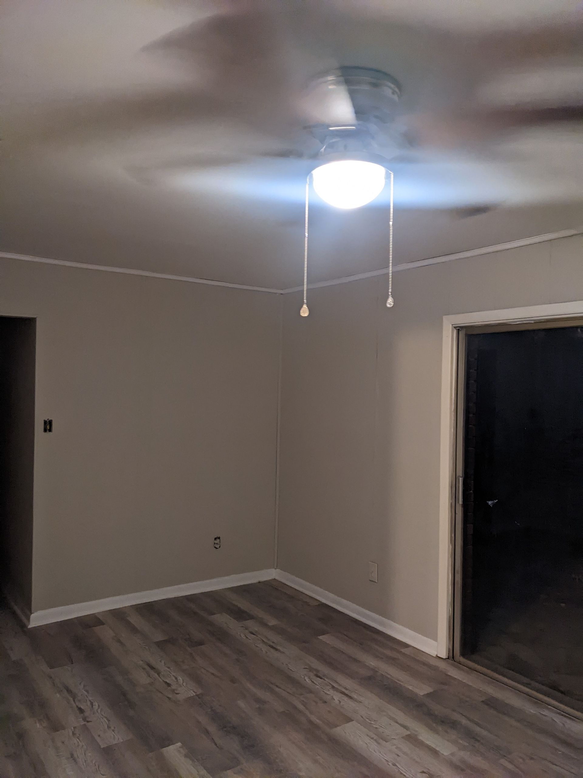 There is a ceiling fan in the corner of the room.
