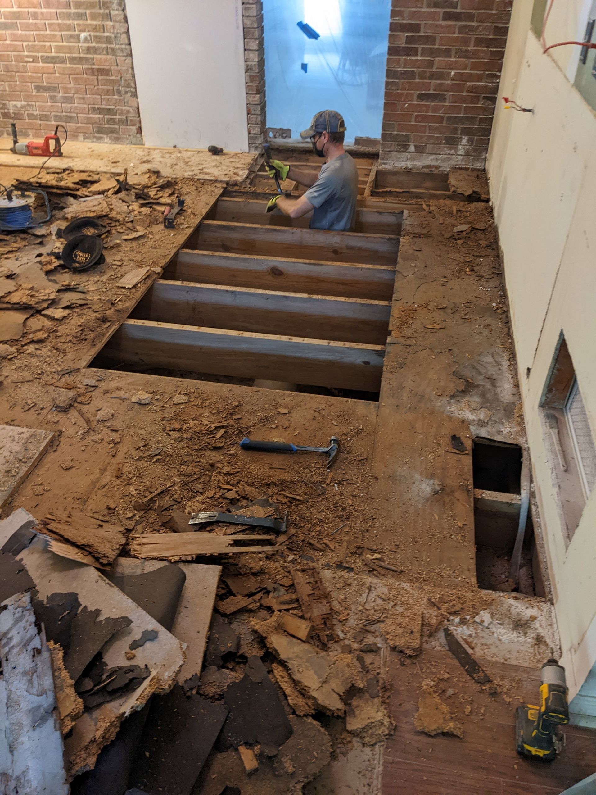 A man is working on the floor of a building