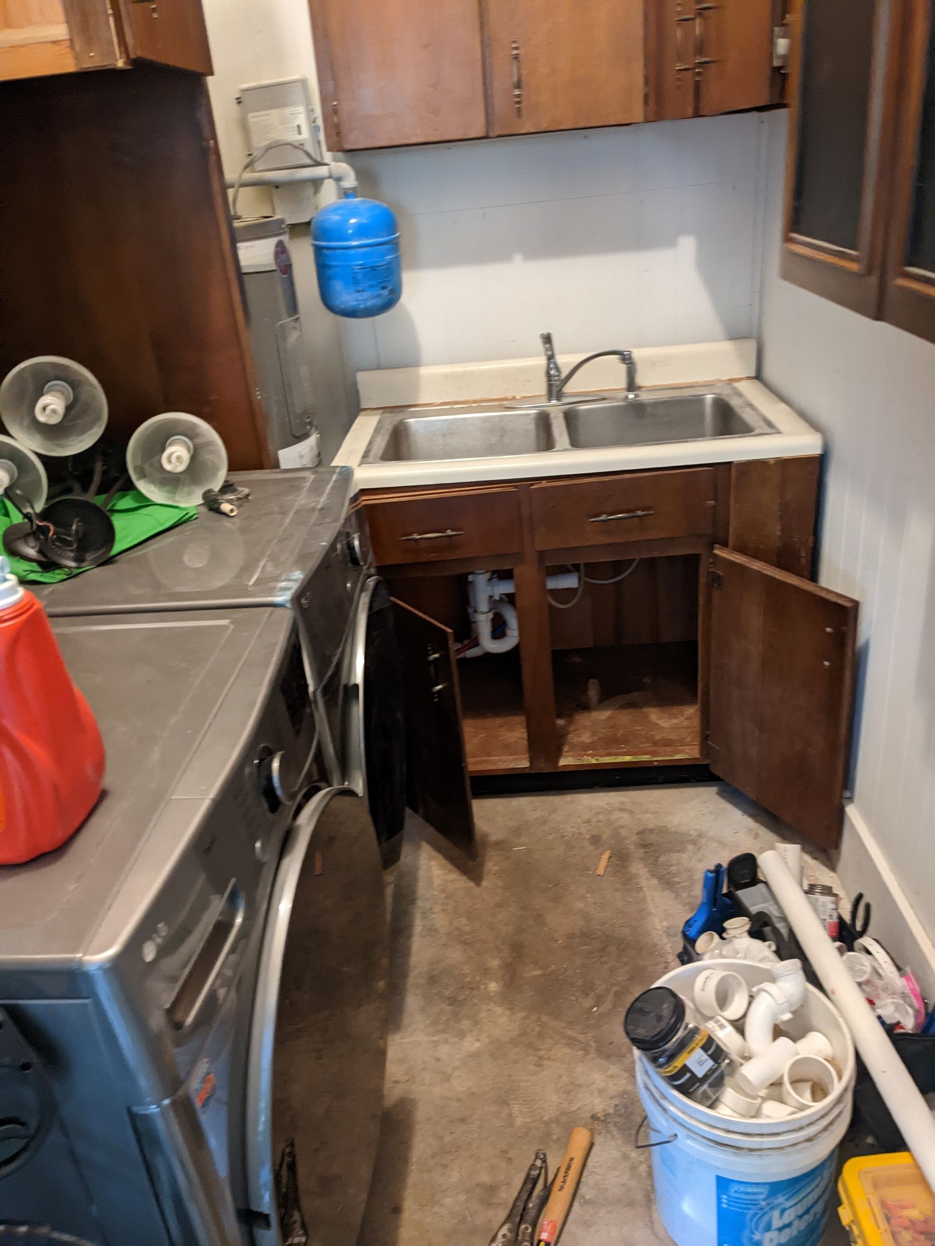 A laundry room with a washer and dryer and a sink.