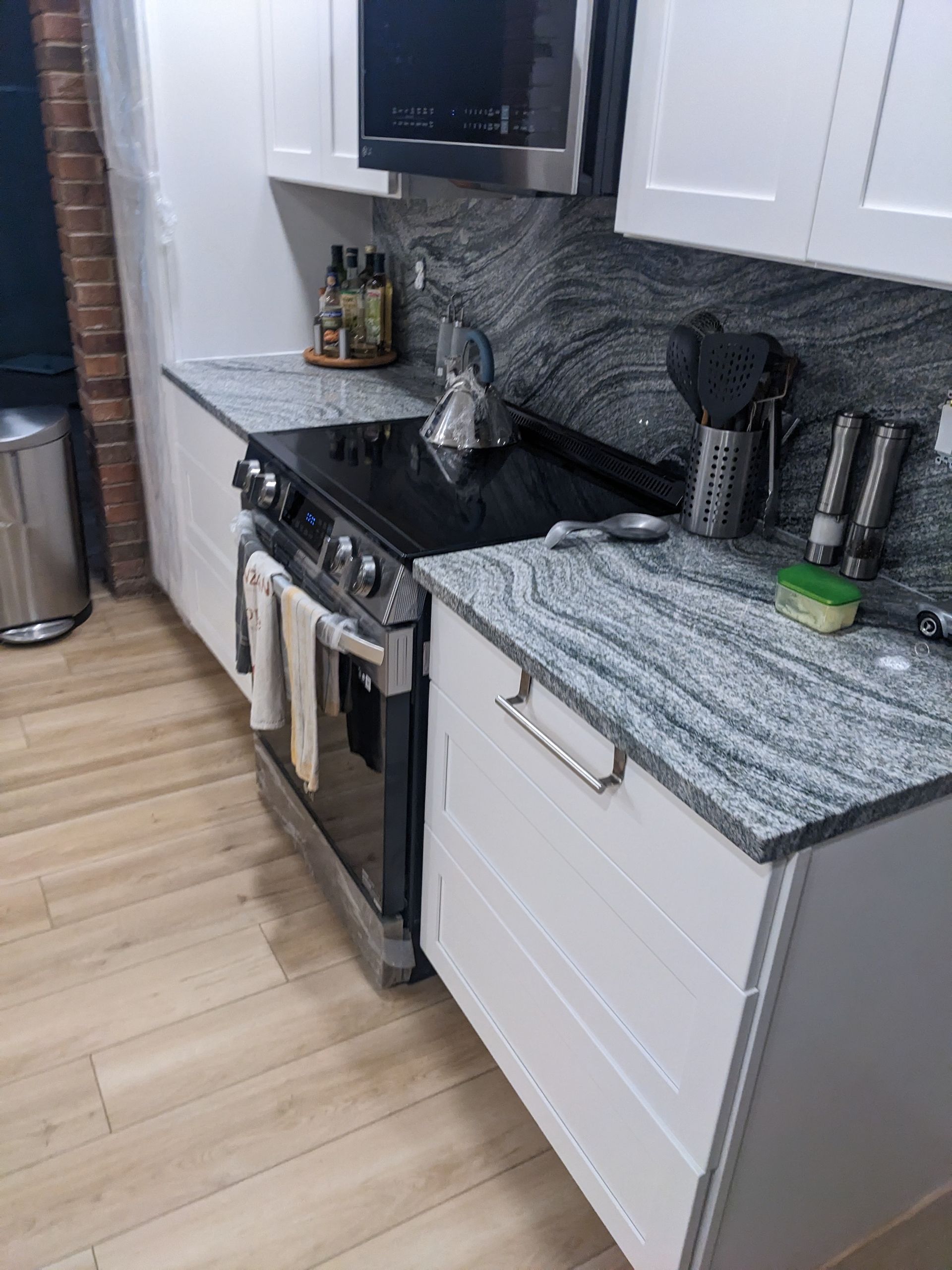 A kitchen with stainless steel appliances and granite counter tops.