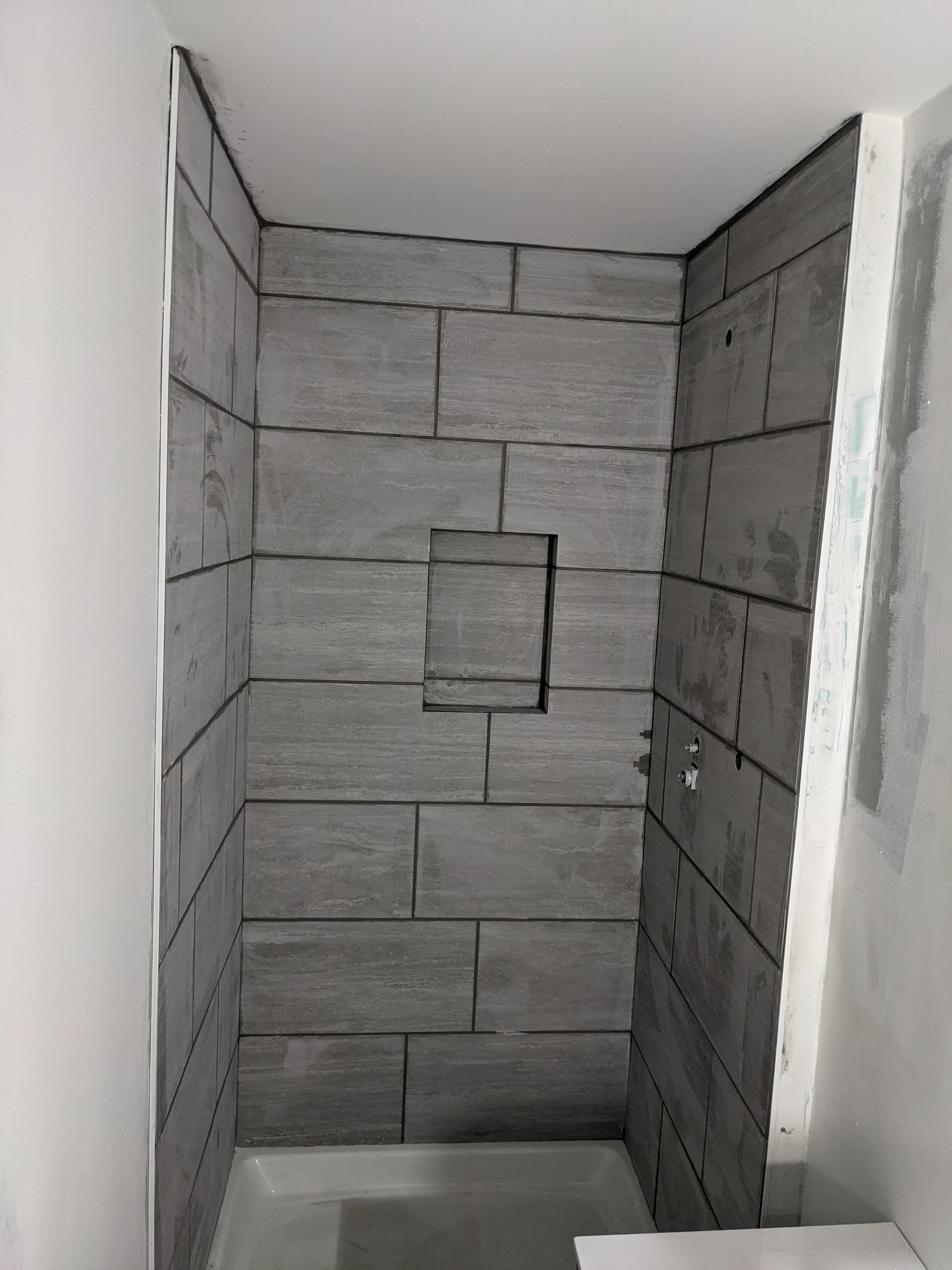 A bathroom with a shower stall and a toilet.