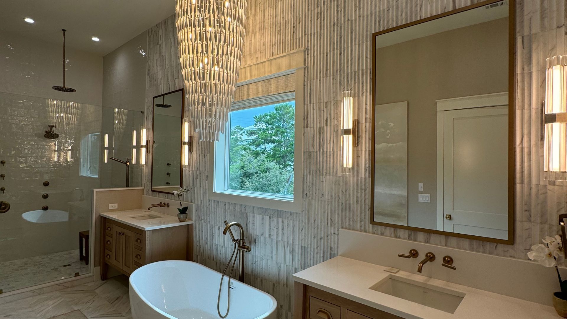 A bathroom with a bathtub , sink , mirror and shower.