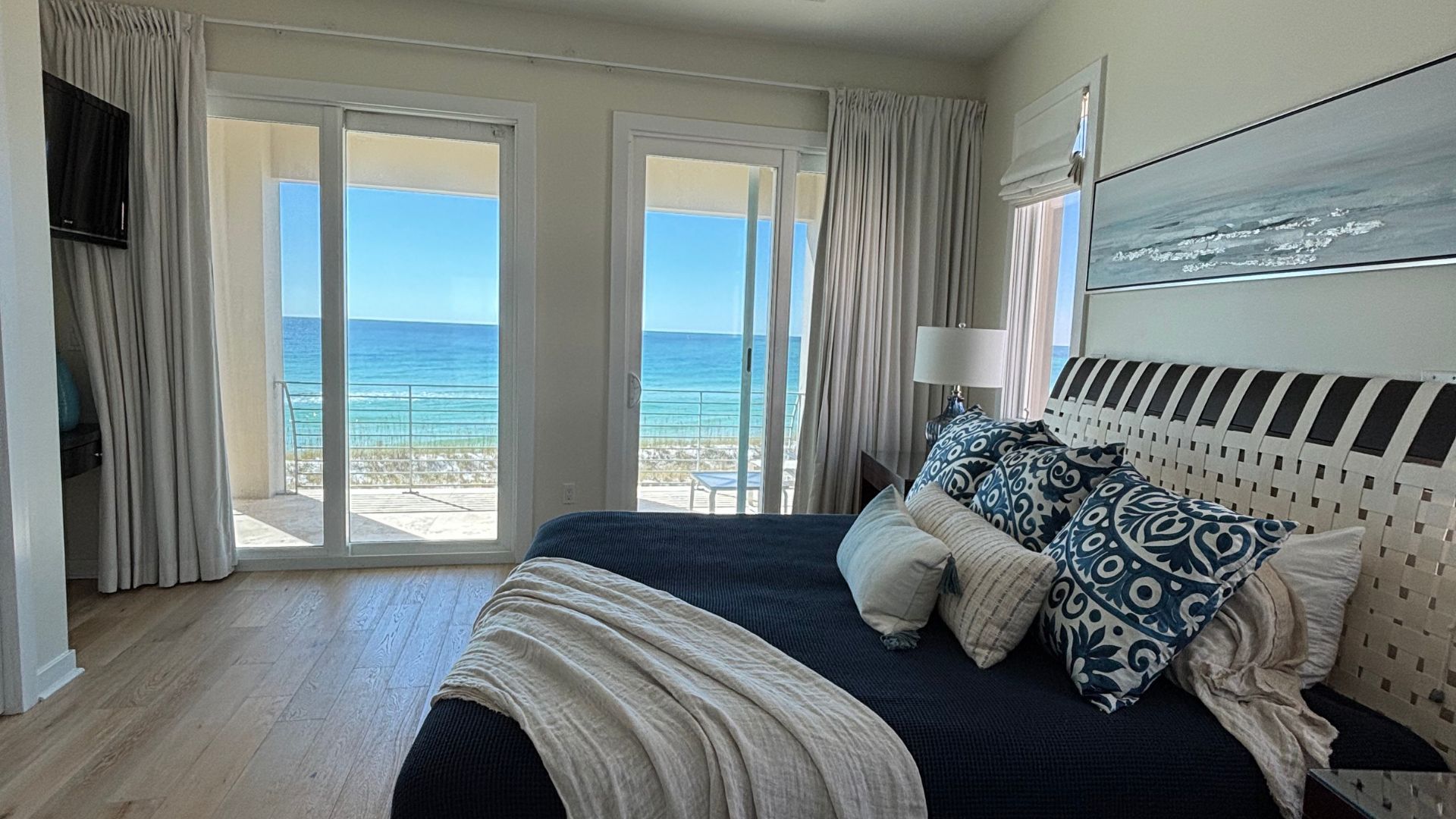 A bedroom with a large bed and a view of the ocean.