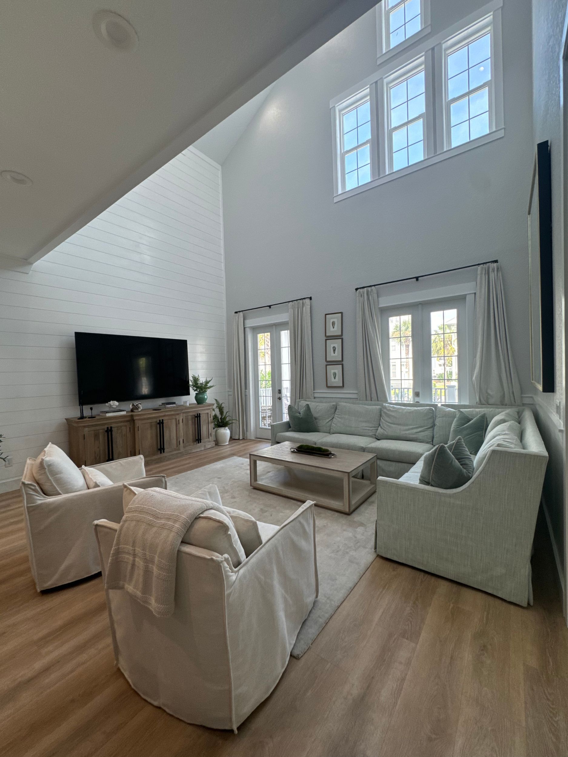 A kitchen with a wooden table and chairs and a wooden ceiling.