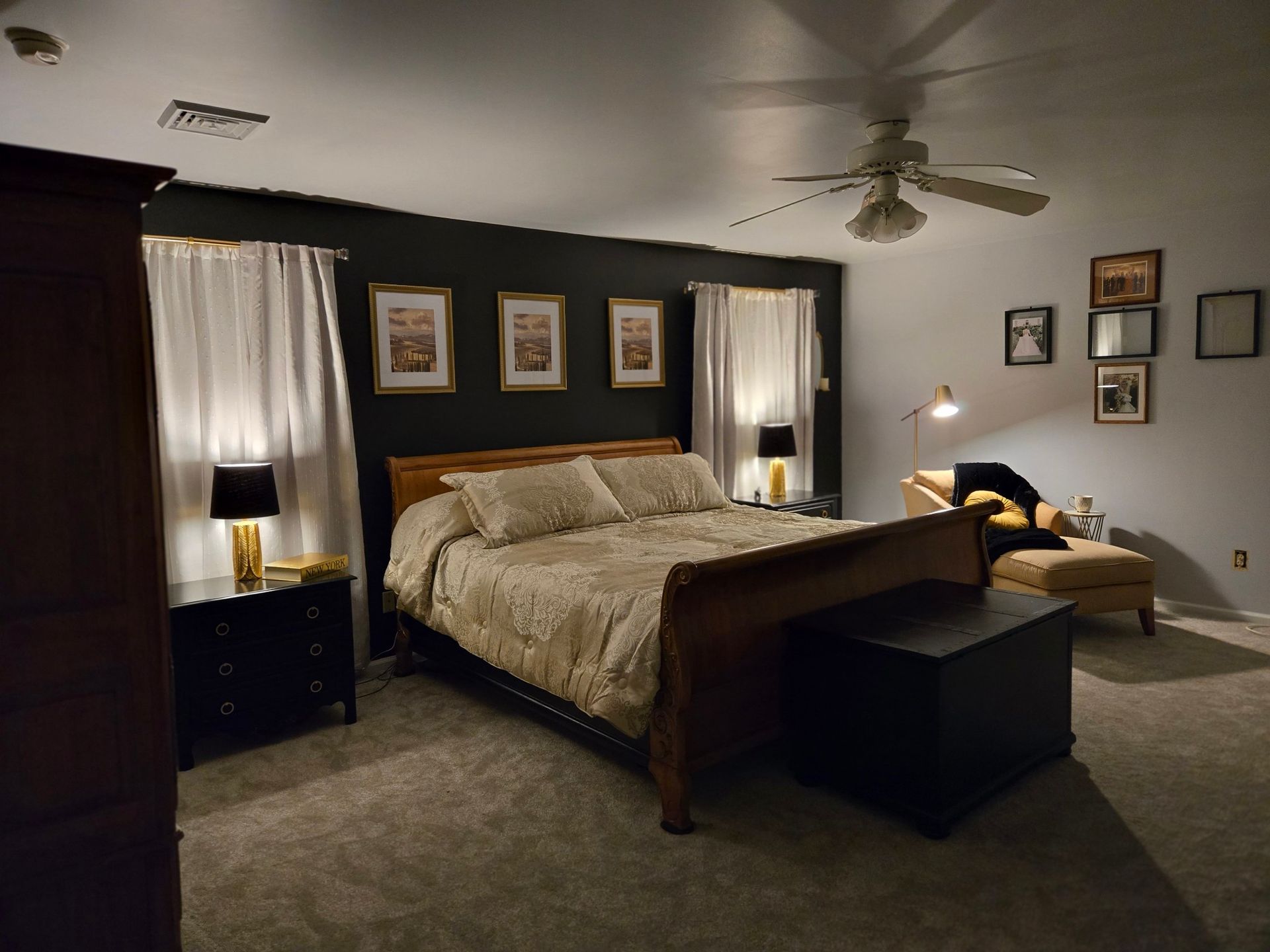 A bedroom with a large bed and a ceiling fan