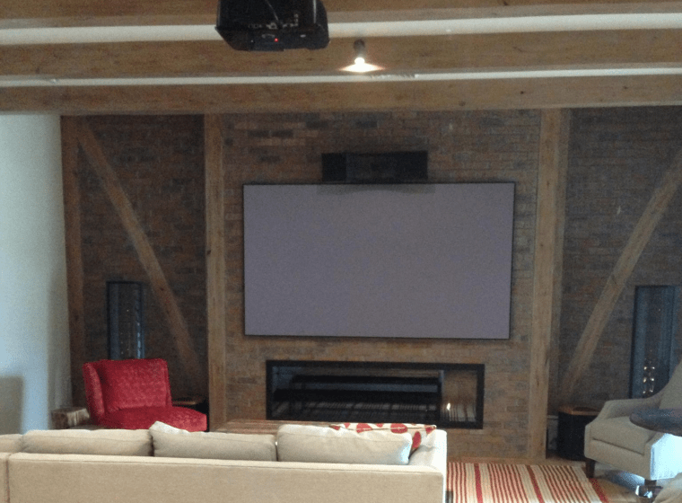 A living room with a fireplace and a flat screen tv