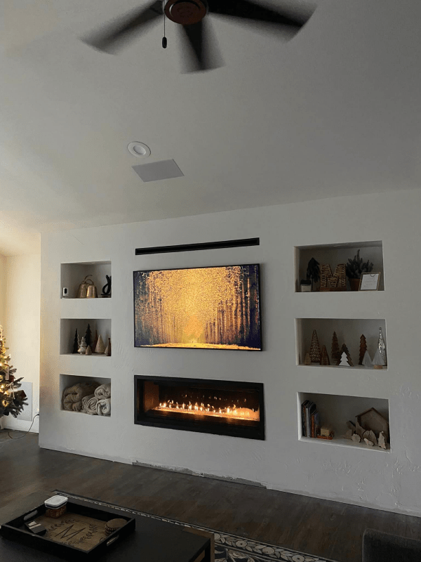 A living room with a fireplace and a flat screen tv