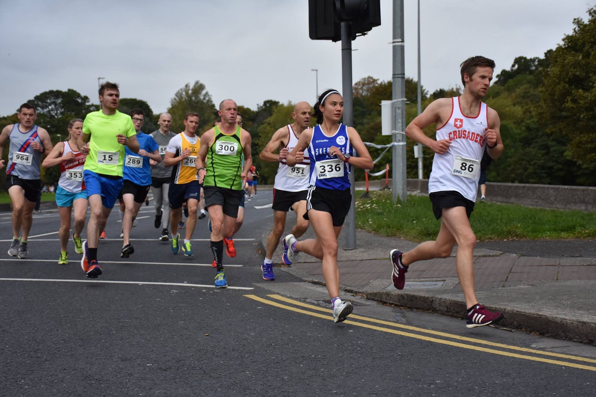 A group of people are running down a street.
