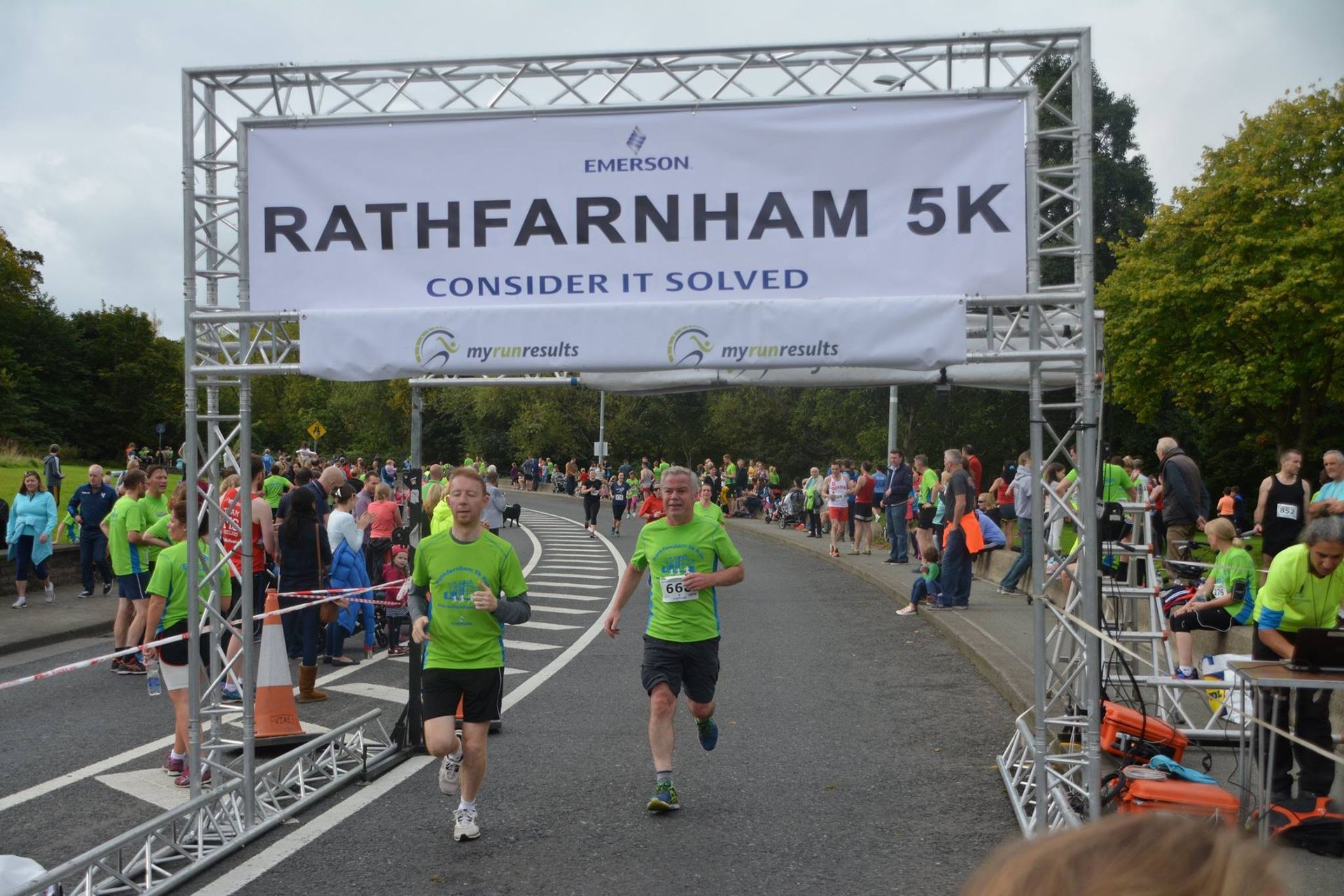 A group of people are running in a rathfarnham 5k race