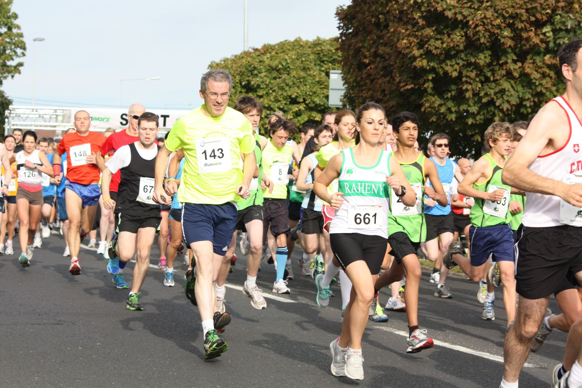 A group of people are running a race and one of them has the number 143 on his shirt