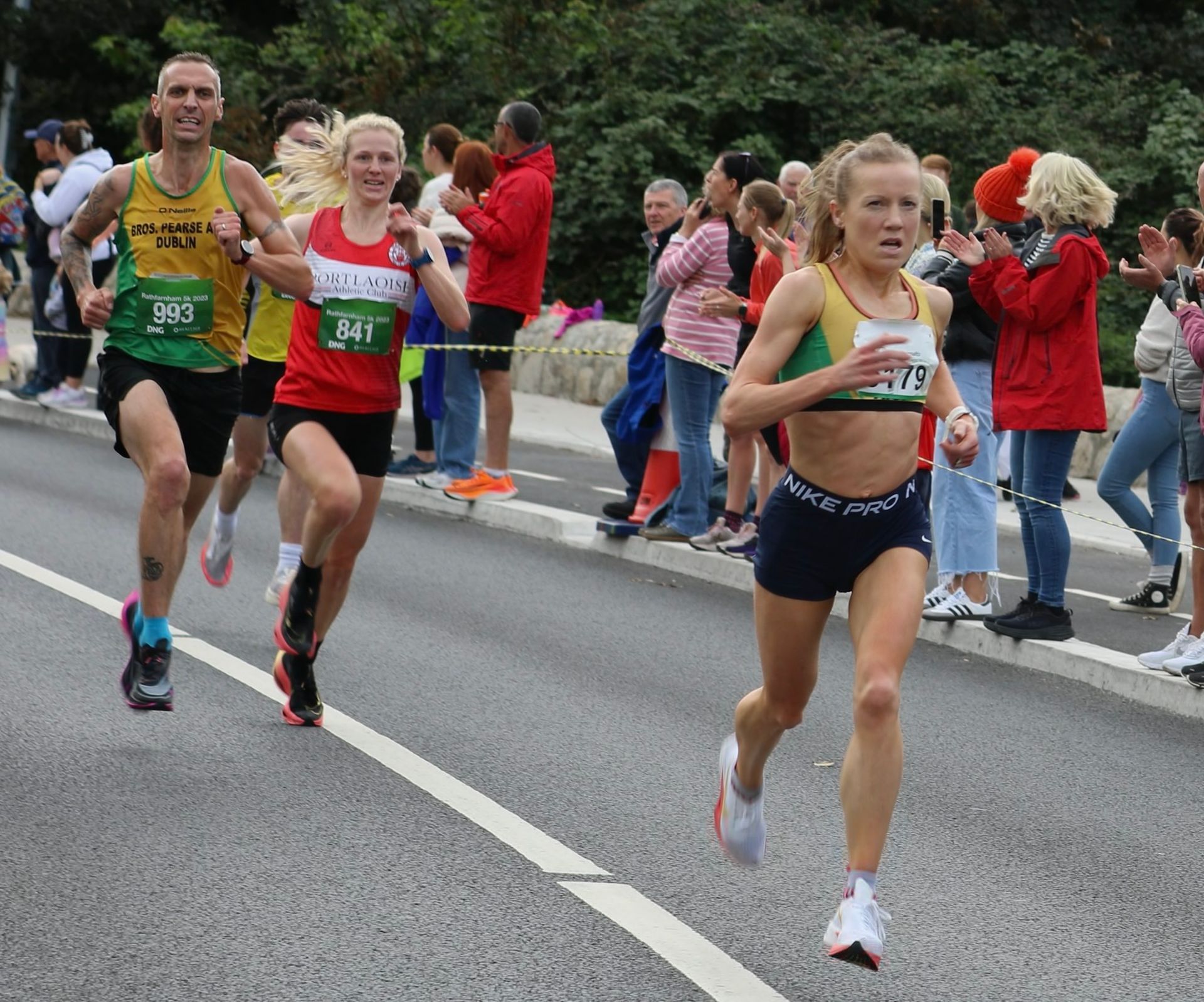 A group of people are running a marathon on a street.