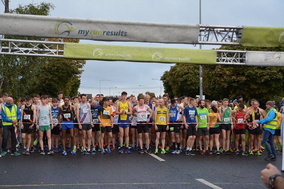 A group of people are standing in front of a sign that says my results.