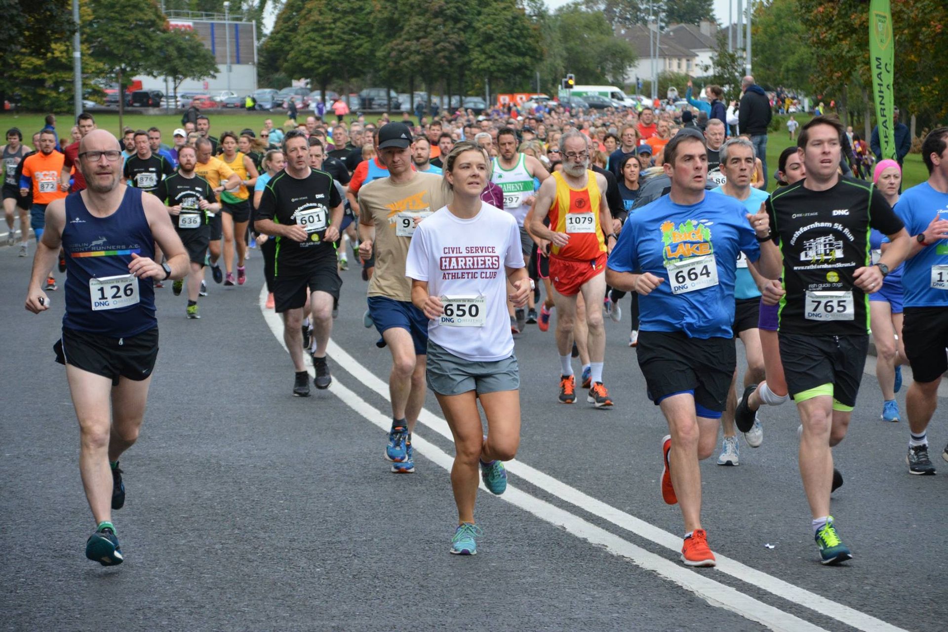 A group of people are running a marathon on a street.