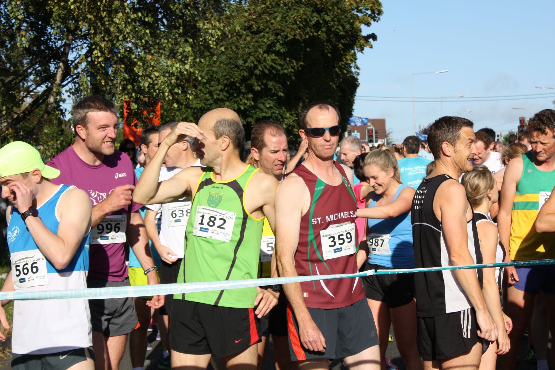 A group of runners are lined up at the start of a race