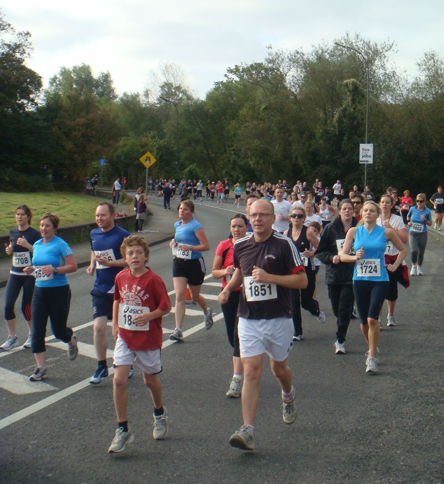 A group of people are running a race and one of them has the number 1851 on his shirt