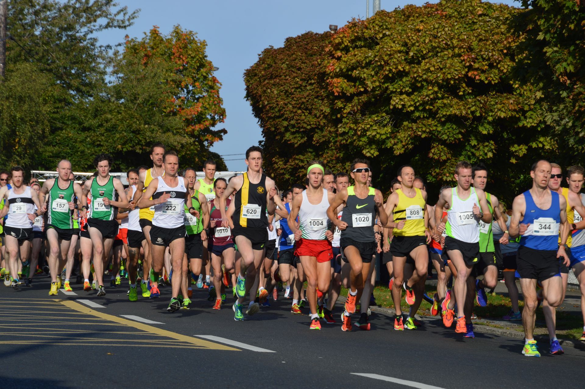 A group of people are running a marathon on a street.