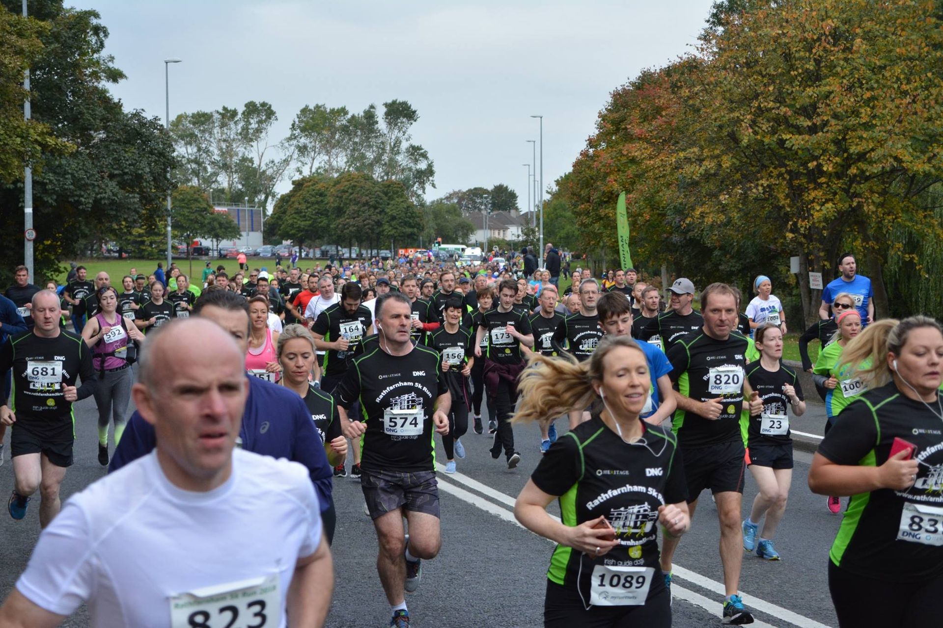 A group of people are running a marathon on a street.