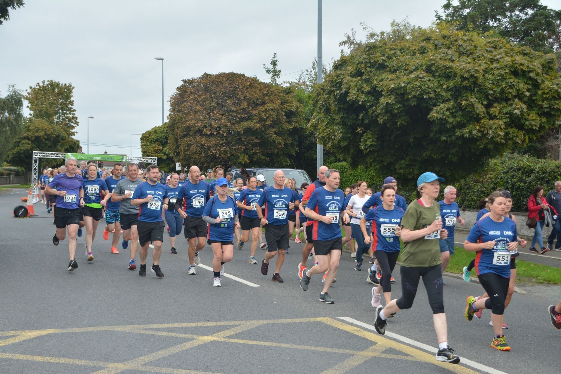 A group of people are running down a street.