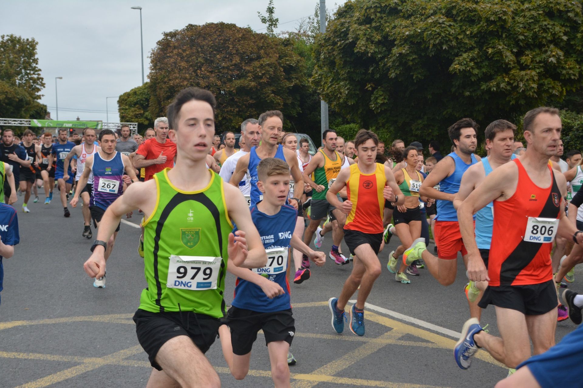 A group of people are running a marathon on a street.