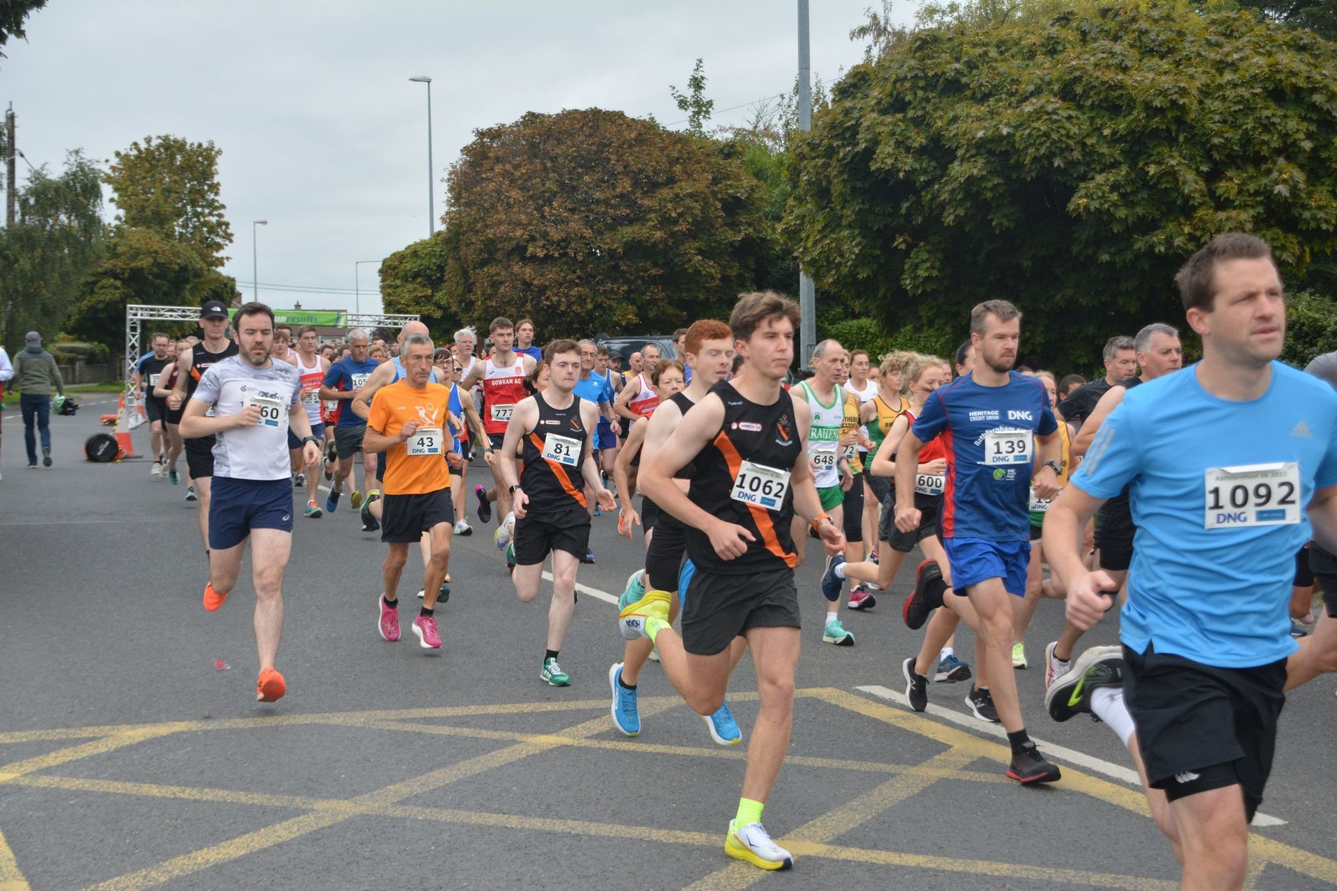 A group of men are running a race and one of them has the number 1092 on his shirt