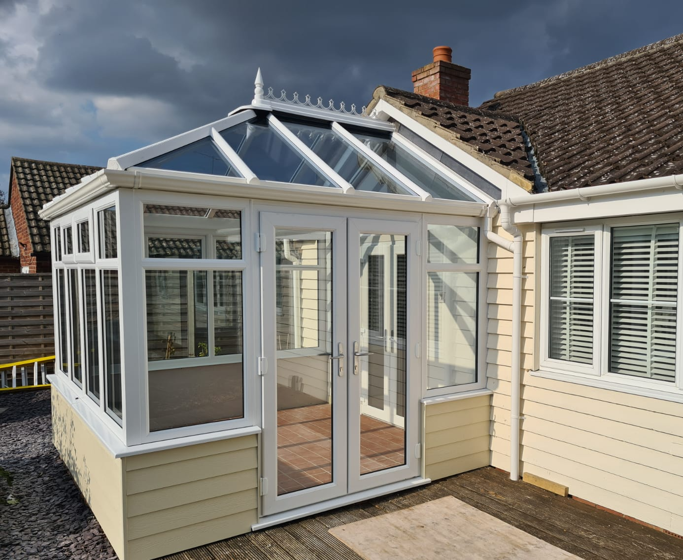 Yellow house with conservatory installation