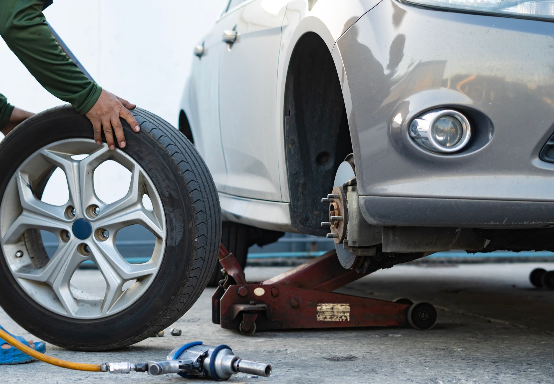 Mechanic repairing tires - Burton, MI - Dort Highway Auto Service