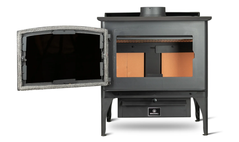 Wood-burning stove with flames visible in the glass door, with a black metal body, set in a room.