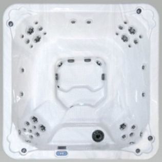 Overhead view of a white, square hot tub with multiple jets.