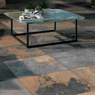 Glass-topped coffee table on a tiled floor with orange, gray, and blue tones.