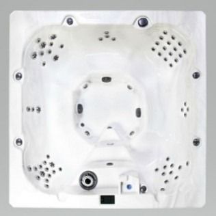 Top-down view of a white, square hot tub with multiple jets and an inset seating area.