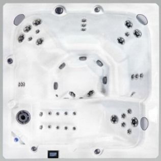 Overhead view of a white, multi-person hot tub with various jet and control placements.