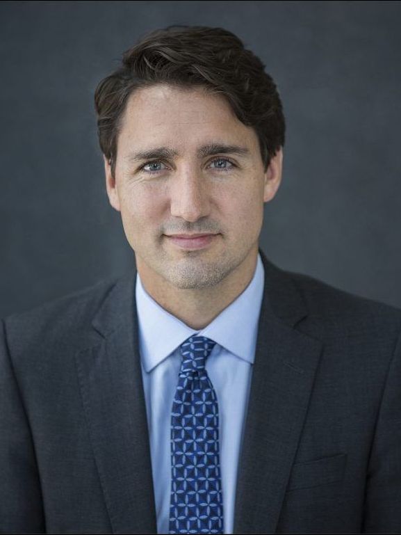 A man in a suit and tie is smiling for the camera.