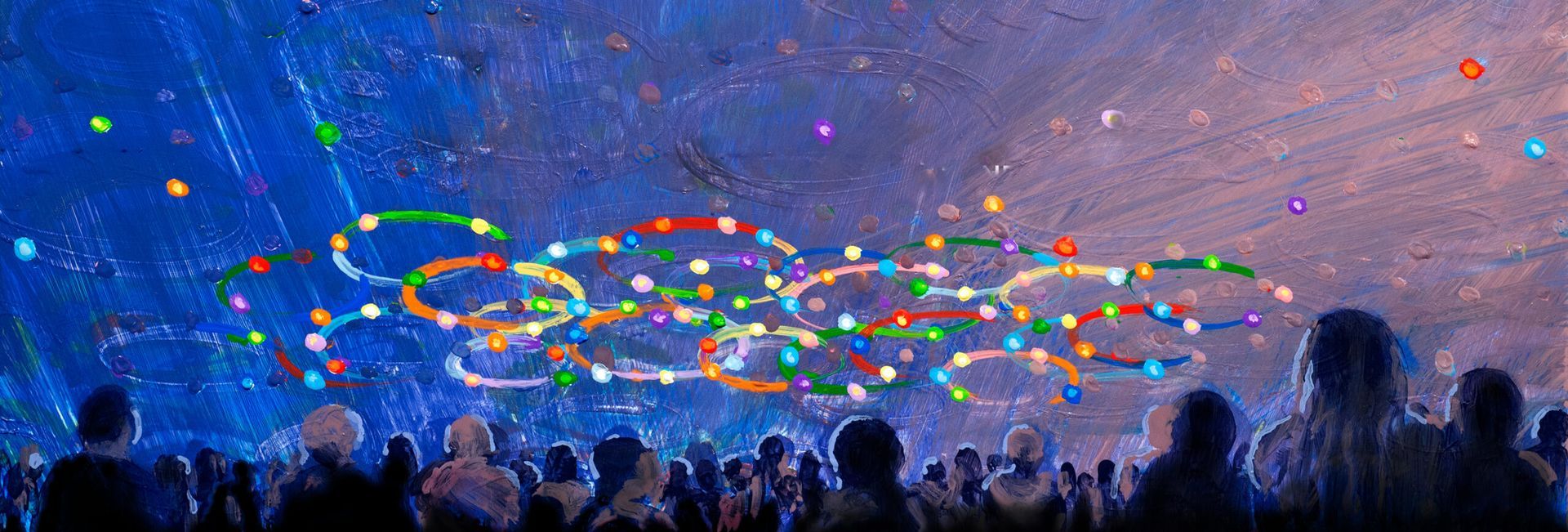 A crowd of people are watching a display of confetti in the sky.