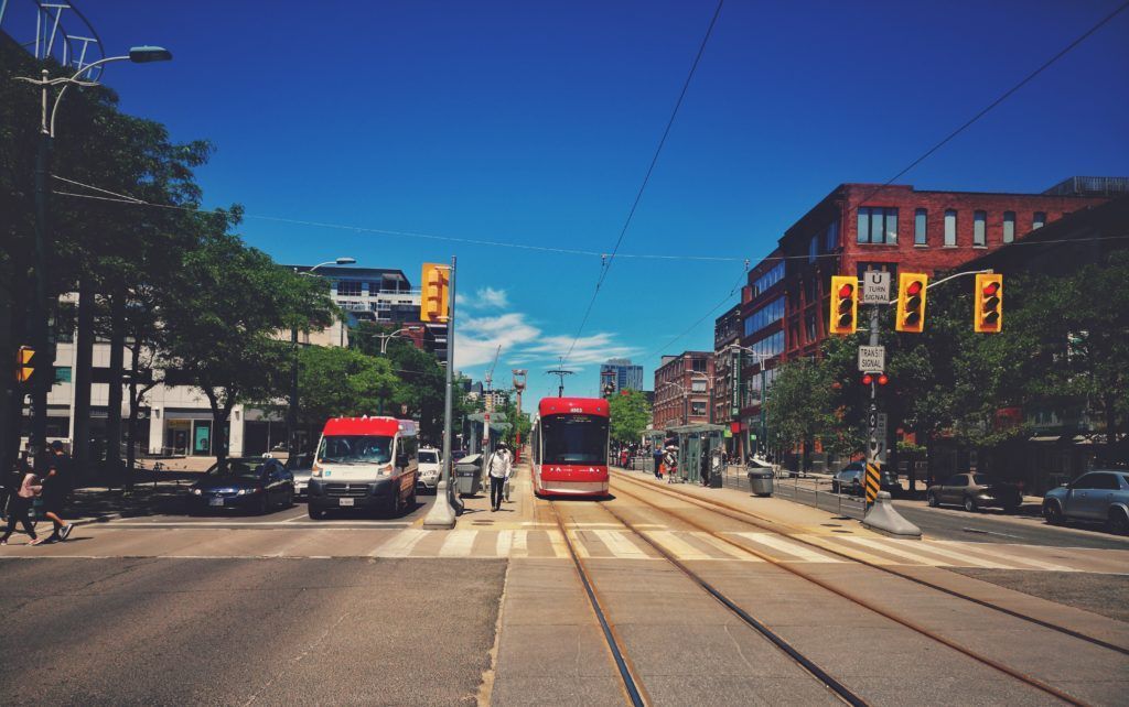 A photo of a public transit streetcar in the city of Toronto on a sunny, summer day