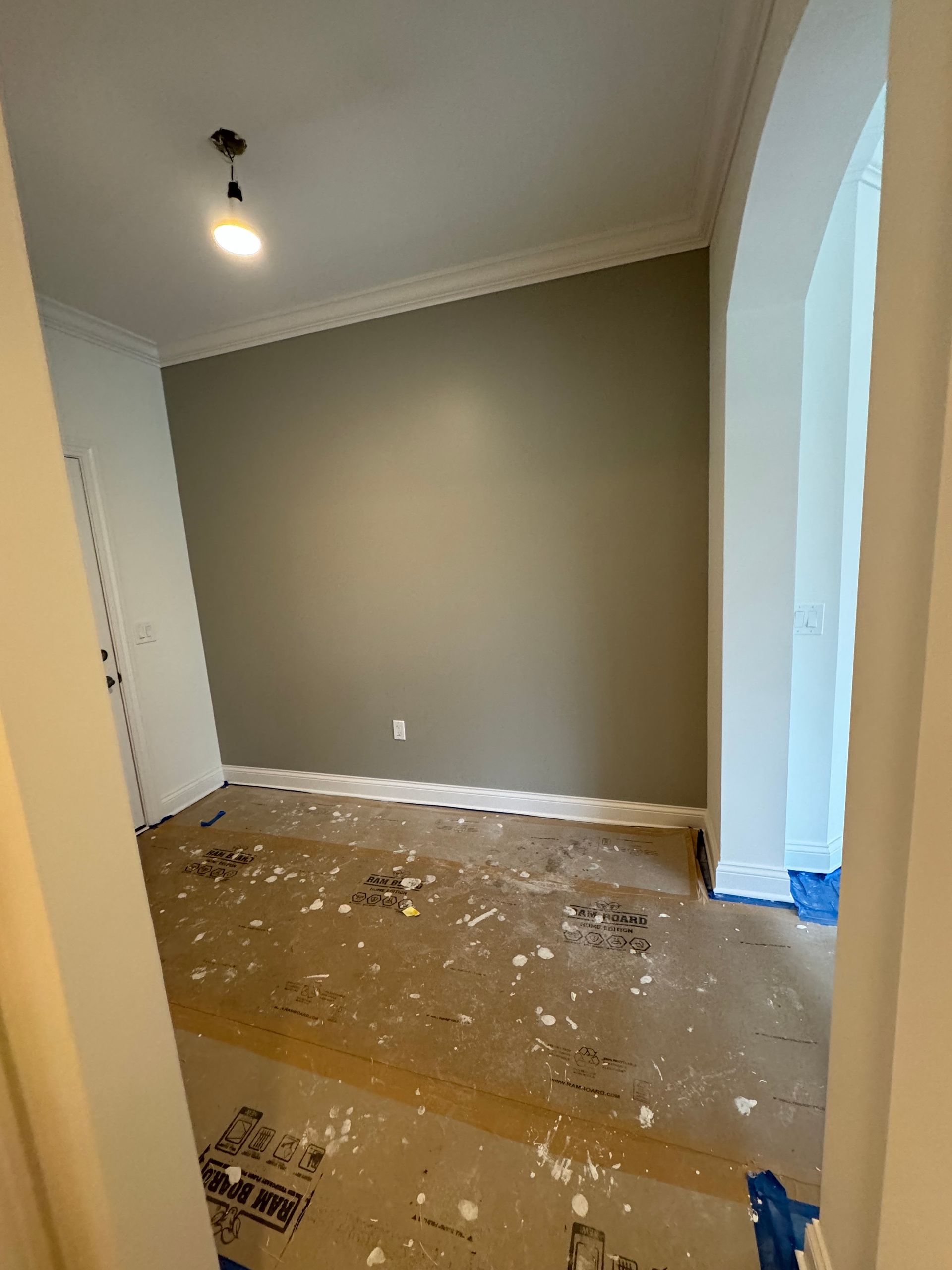 A room with a lot of paint on the floor and walls.