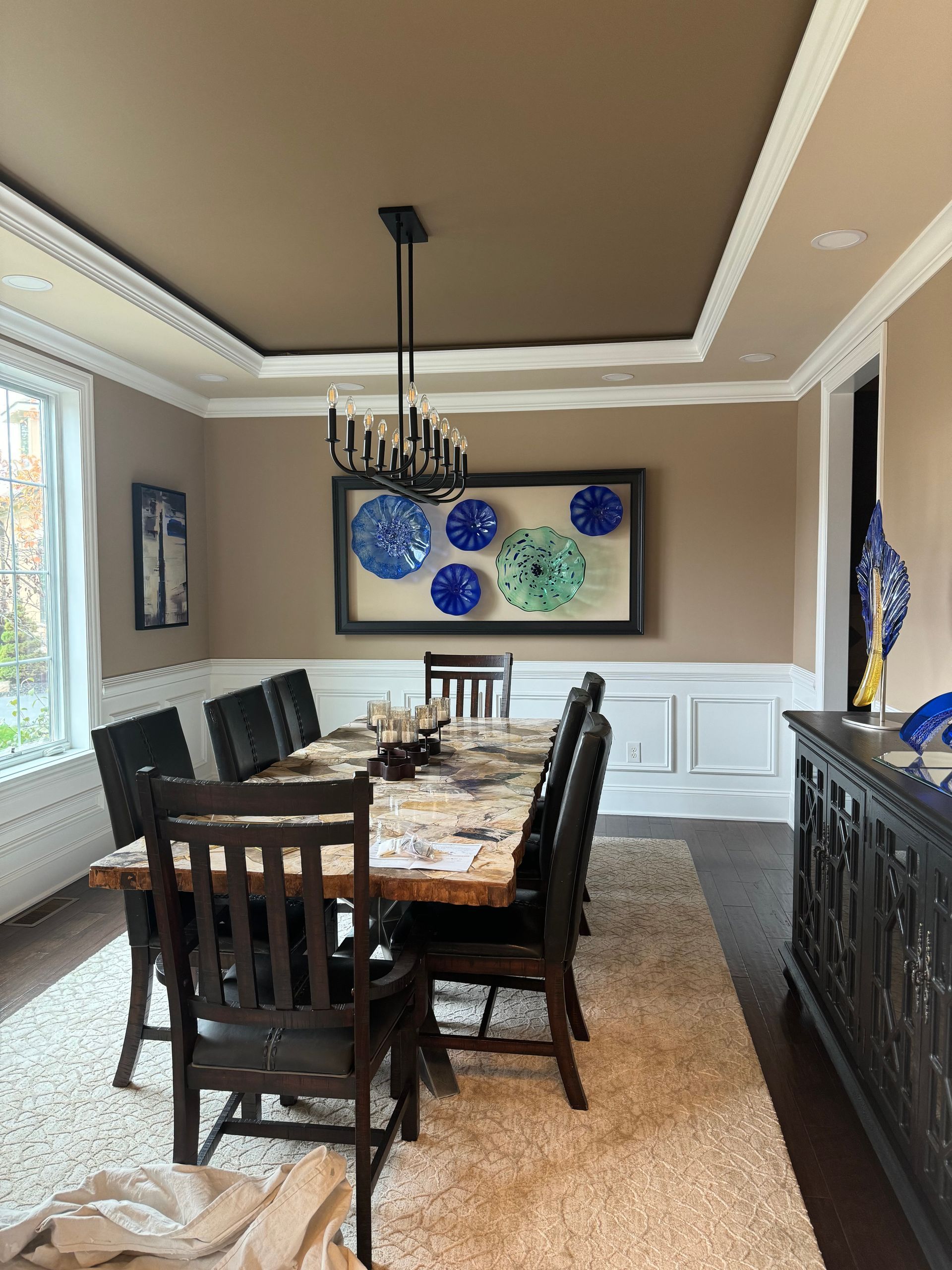 A dining room with a table and chairs and a chandelier