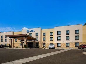 Reinforced steel grid (rebar) in a construction site, set in a rectangular formation against a dirt wall.