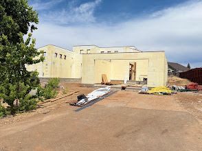 Construction site with ICF walls, supported by adjustable braces and scaffolding; exterior shot.