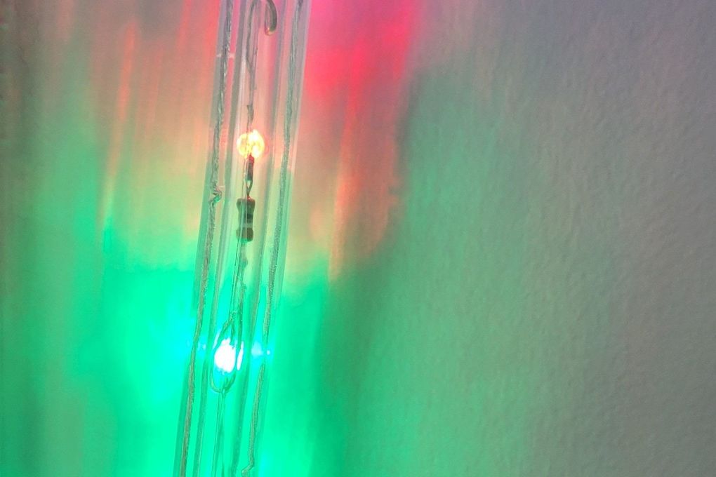 A bunch of christmas lights are hanging from the ceiling.